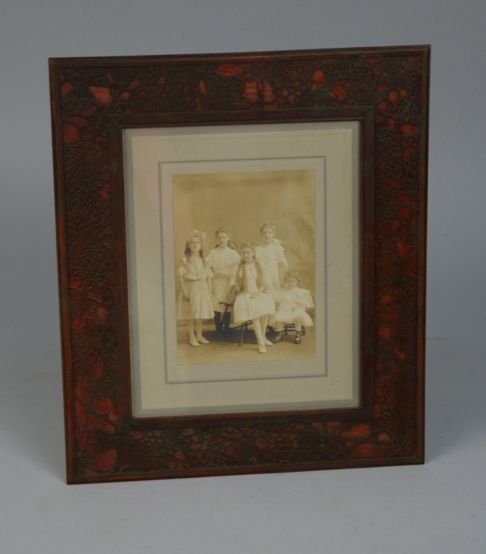 TIFFANY STUDIOS PATINATED BRONZE AND GLASS PICTURE FRAM: TIFFANY STUDIOS PATINATED BRONZE AND GLASS PICTURE FRAME; inscribed Tiffany Studios, New York, 916; 14 x 12 inches