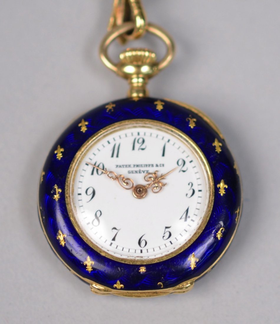 PATEK PHILIPPE 18K YELLOW GOLD, DIAMOND, AND ENAMEL PEN: PATEK PHILIPPE 18K YELLOW GOLD, DIAMOND, AND ENAMEL PENDANT WATCH with fleur de lis decoration; case marked No. 103256 Patek Philippe & Cie Geneve and 215043, together with a black grosgrain lanyard w