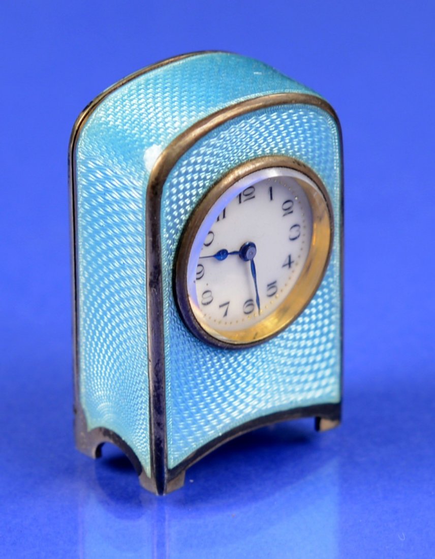 FRENCH PALE BLUE ENGINE TURNED ENAMEL AND SILVER GILT: FRENCH PALE BLUE ENGINE TURNED ENAMEL AND SILVER GILT "PENDULETTE DE VOYAGE MINIATURE" the base marked Argent Dore, No. 5074; in original fitted leather case with key; height of clock: 1 7/8 inches