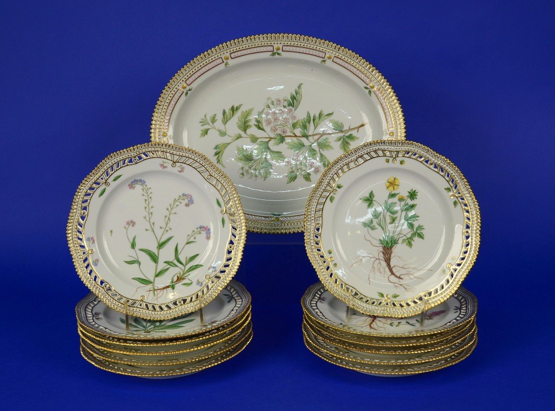 SET OF TWELVE ROYAL COPENHAGEN FLORA DANICA LUNCHEON: SET OF TWELVE ROYAL COPENHAGEN FLORA DANICA LUNCHEON PLATES and an OVAL SERVING DISH; Danish, 20th century; diameter of plates: 9 inches; length of dish: 14 1/2 inches