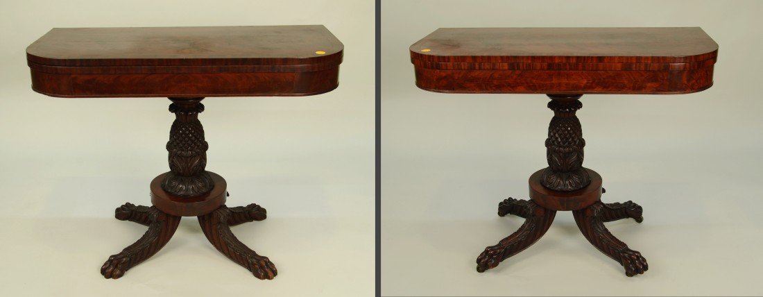 PAIR OF CLASSICAL CARVED MAHOGANY GAMES TABLES, circa: PAIR OF CLASSICAL CARVED MAHOGANY GAMES TABLES, circa 1825; with pineapple carved pedestal and paw feet; height: 29 1/2 inches; width: 36 1/2 inches; depth: 18 inches