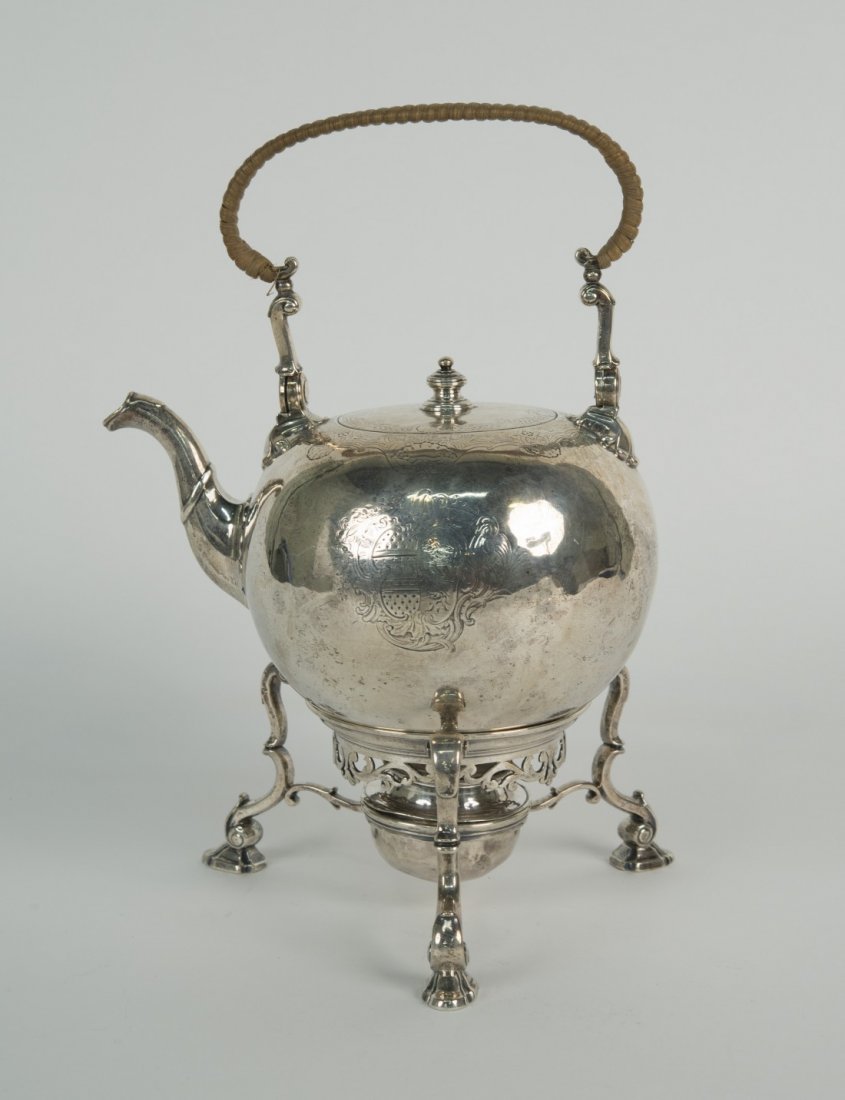GEORGIAN SILVER HOT WATER KETTLE: GEORGIAN SILVER HOT WATER KETTLE, London, ca. 1730, marked L.S., possibly for John Swift; length: 9 in.; weight: 37 ozs.; together with a COMPLIMENTARY SILVER STAND WITH BURNER, unmarked, weight: 19 o