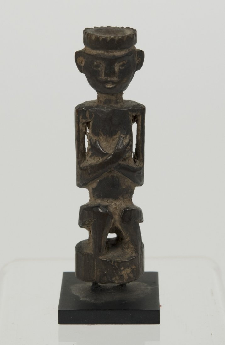 SMALL INDONESIAN CARVED WOOD FIGURE WITH CROSSED ARMS;: SMALL INDONESIAN CARVED WOOD FIGURE WITH CROSSED ARMS; height: 3 in. Provenance: Property of a New York City family.