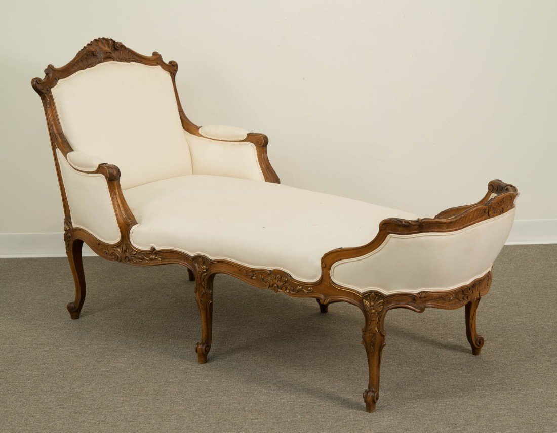 LOUIS XV STYLE CARVED WALNUT CHAISE LONGUE;: LOUIS XV STYLE CARVED WALNUT AND UPHOLSTERED CHAISE LONGUE; height: 36 in., length: 63 in.