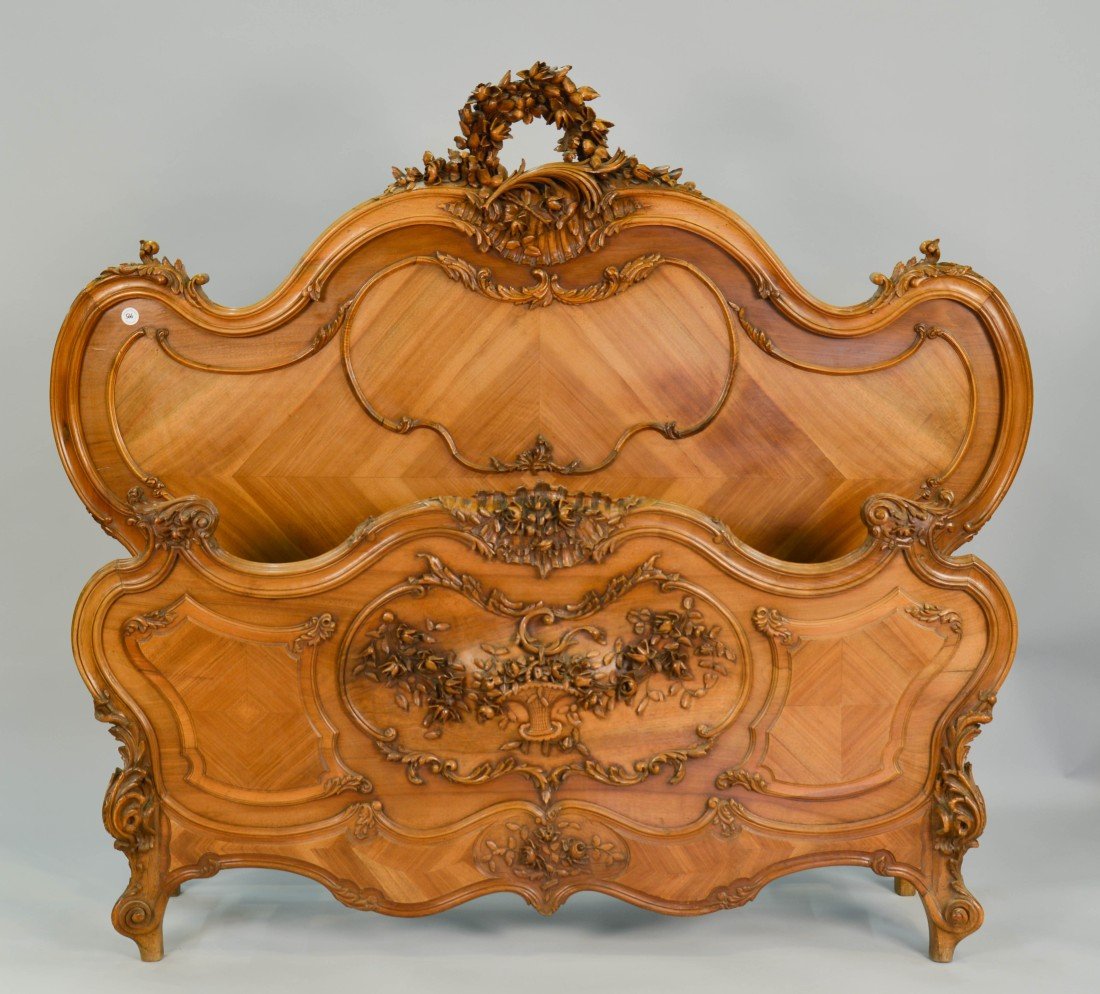 LOUIS XV STYLE ROCOCO CARVED WALNUT BED;: LOUIS XV STYLE ROCOCO CARVED WALNUT BED; height: 63 in., headboard width: 70 in., interior width: 56 in. Other Notes: This bed compliments lot 187, an armoire. Could be fitted for Queen mattress.