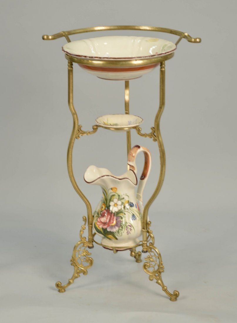LOUIS XV STYLE BRASS AND PORCELAIN INSET WASH STAND;: LOUIS XV STYLE BRASS AND PORCELAIN INSET WASH STAND; including a porcelain basin, soap dish and pitcher; height of stand: 32 in.; diameter of wash bowl: 14 in.