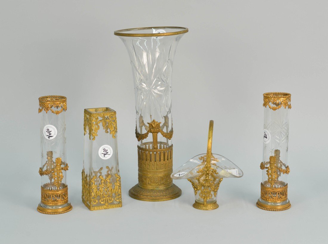 FIVE NAPOLEON III STYLE GILT METAL MOUNTED DECORATIONS;: FIVE NAPOLEON III STYLE GILT METAL MOUNTED CRYSTAL DECORATIONS; including a tall vase, two cylinder vases, a square vase and basket; height of tallest vase: 15 in.
