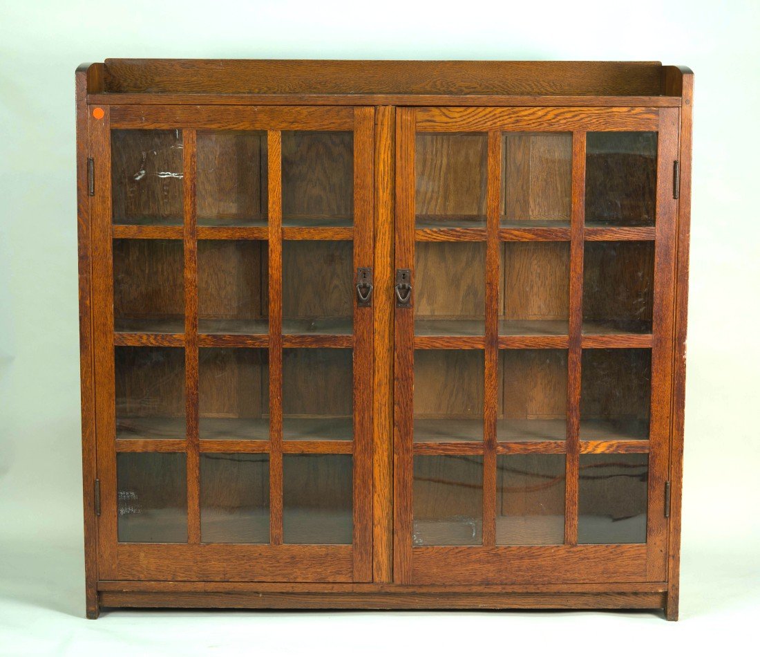 GUSTAV STICKLEY TWO DOOR BOOKCASE;: GUSTAV STICKLEY TWO DOOR BOOKCASE; bearing 1905-1912 Craftsman Workshop Mark in red; model #719; with 2 twelve panelled glazed doors; height: 56 in.; width: 60 in.; depth: 12 3/4 in.