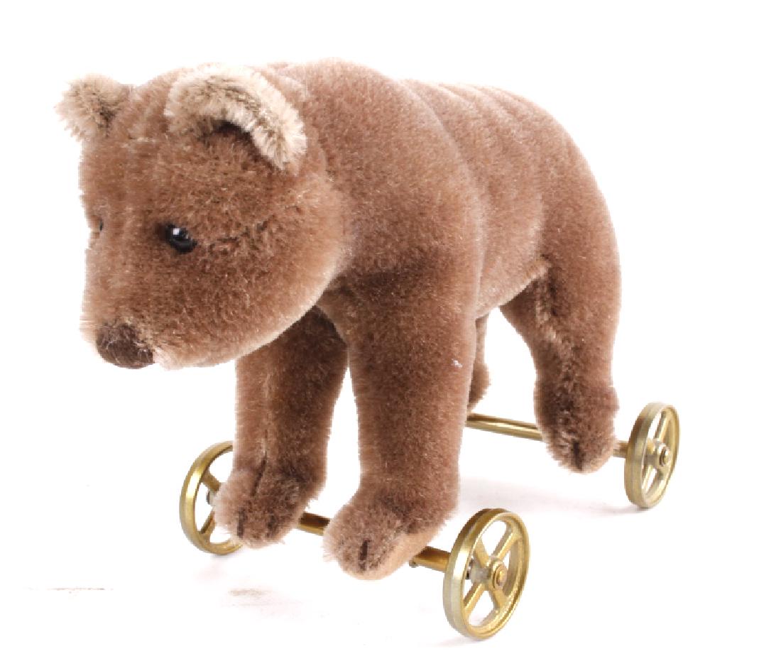 Steiff Bear On Wheels: This lot features a Steiff Bear on wheels. Steiff is a German-based plush toy company. It was founded in 1880 by Margarete Steiff, who was later assisted by her brother Fritz. Steiff is best know for 
