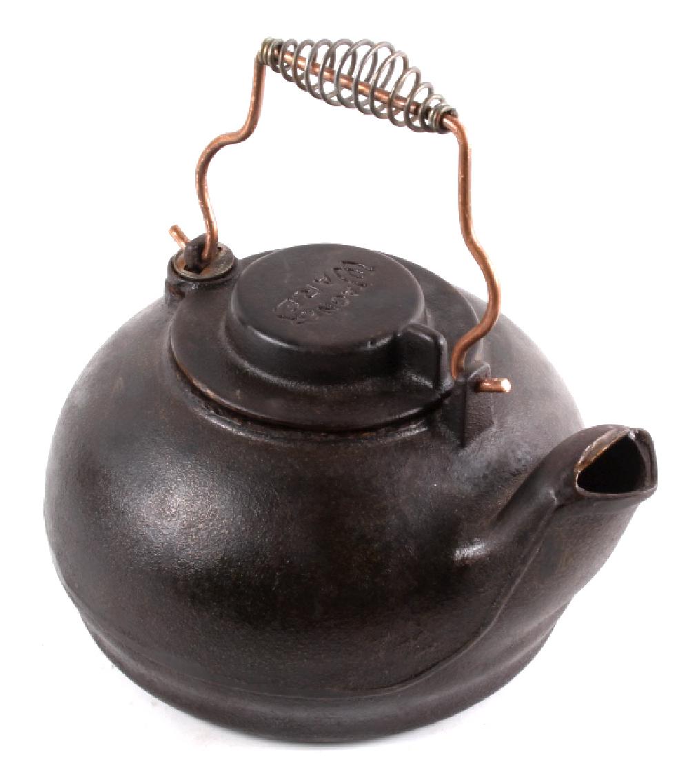 Cast Iron Wagner Swivel Lid Tea Kettle: This is Wagner Ware cast iron swivel lid tea kettle. This tea kettle is of heavy cast construction featuring its gooseneck form spout, bale handle with heat protector, and swivel lid. Wagner Manufactu