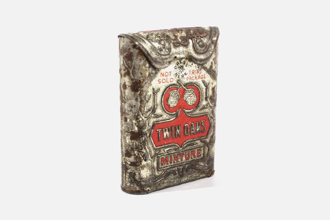 Twin Oaks Mixture Gentlemen's Pocket Tobacco Tin: This lot features a great example of a Twin Oaks Mixture Gentlemen's Pocket Tobacco Tin. The tin displays a ornate embossed design with red highlights and lettering, the front has the twin oaks acorns