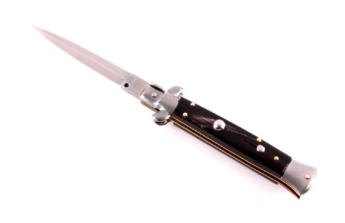 Frank Beltrame Italian Stiletto Switchblade Knife: This is a Frank Beltrame stiletto switchblade knife with a buffalo horn handle. The knife features a bayonet style blade marked "Frank B. Italy". The switchbalde knife is in very good condition with a