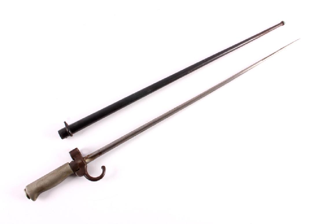 French Model 1886 Lebel Bayonet w/ Scabbard: This is an original French Model 1886 Lebel rifle bayonet with scabbard. The 8mm Lebel rifle was used extensively during WWI and until the fall of France in 1940. Th bayonet shows the distinctive cruc