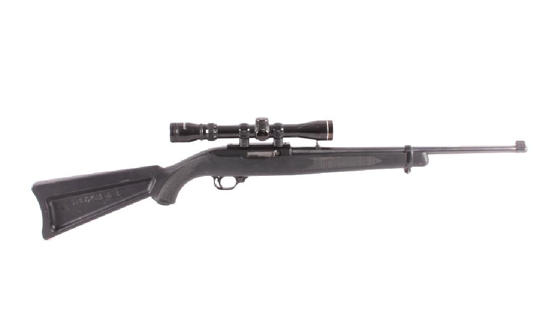 Ruger 10/22 .22 Semi-Automatic Rifle w/ Scope: This is a Ruger 10/22 semi-automatic rifle chambered in the .22 caliber with a Tasco "Silver Antler" 3x9 scope. The rifle features a blued steel barrel and receiver with a synthetic stock marked "Ruge