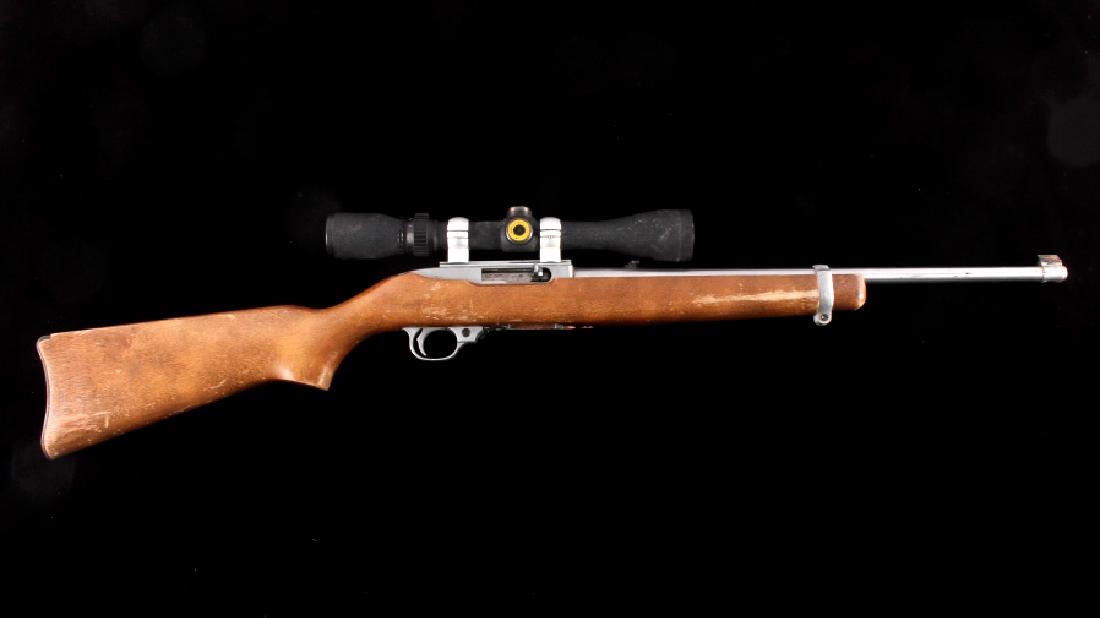 Ruger 10/22 .22 Semi-Automatic Rifle w/ Scope: This is a Ruger 10/22 semi-automatic rifle chambered in the .22 long rifle caliber with a BSA 3-9x40 scope. The rifle features a stainless steel barrel and receiver with a solid walnut hardwood stock.