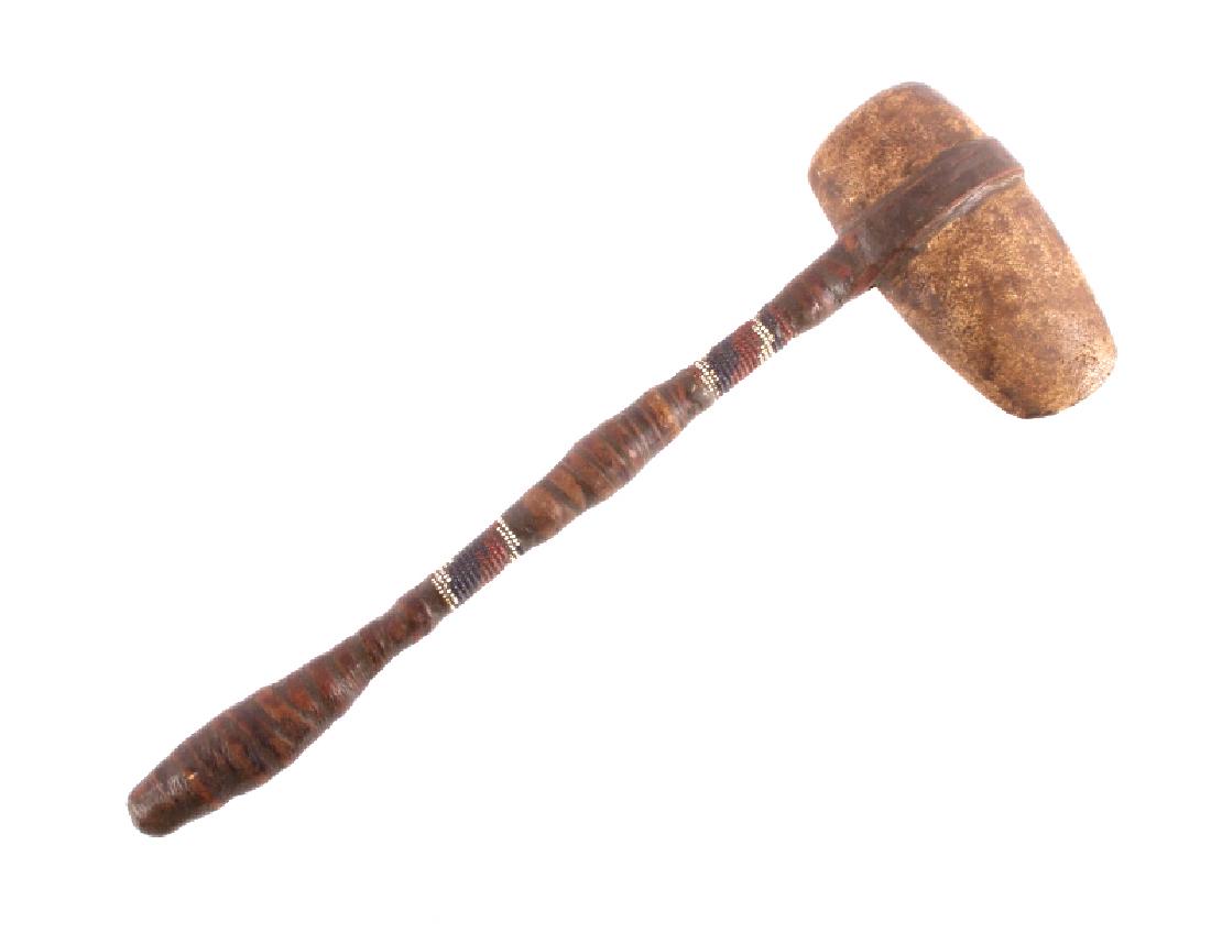 Early 1900's Northern Plains Indian Axe War Club: This is a Northern Plains Native American Indian axe war club from the early 1900's. The war club shows a broad stone head tapered to a point on one end and left blunt on the other. The haft is covere
