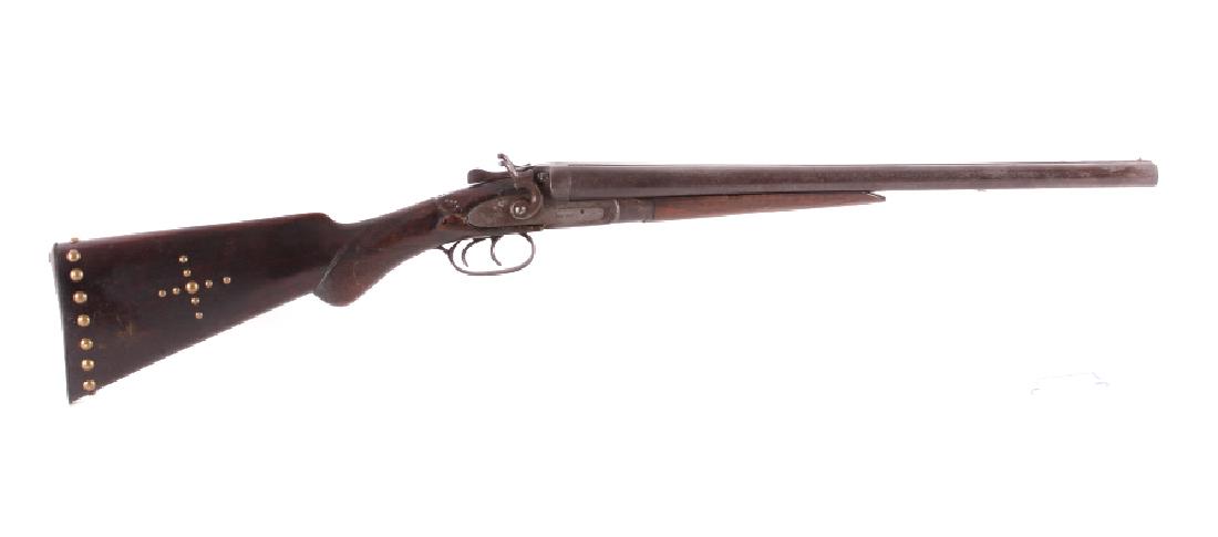 Sam Holt 12ga. Belgian Double Barrel Shotgun: This is a Sam Holt Arms Co. double barrel shotgun chambered in the 12 gauge. The shotgun features a blued steel barrel and receiver with solid walnut hardwood stocks. The top of the barrels is marked 