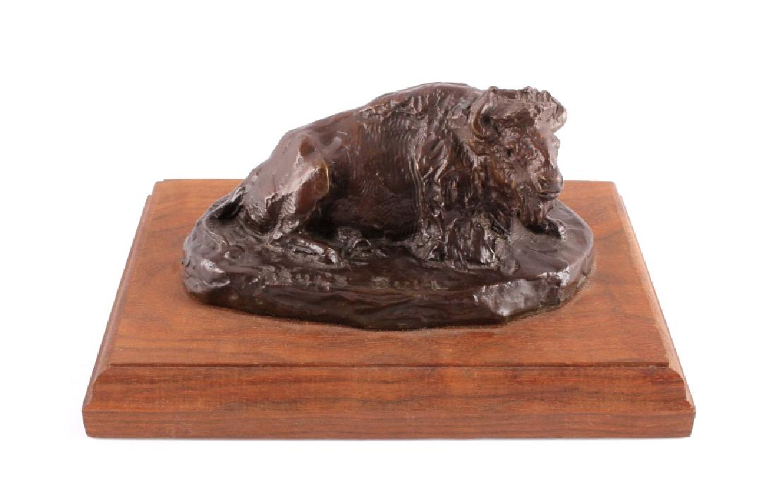 Bob Scriver Original Bronze Sculpture Paul's Bull: This is an original Bob Scriver bronze sculpture titled "Paul's Bull". The piece shows the buffalo laying out on the prairie. Robert Macfie Scriver (1914-1999) was born in Browning, Montana (in the he