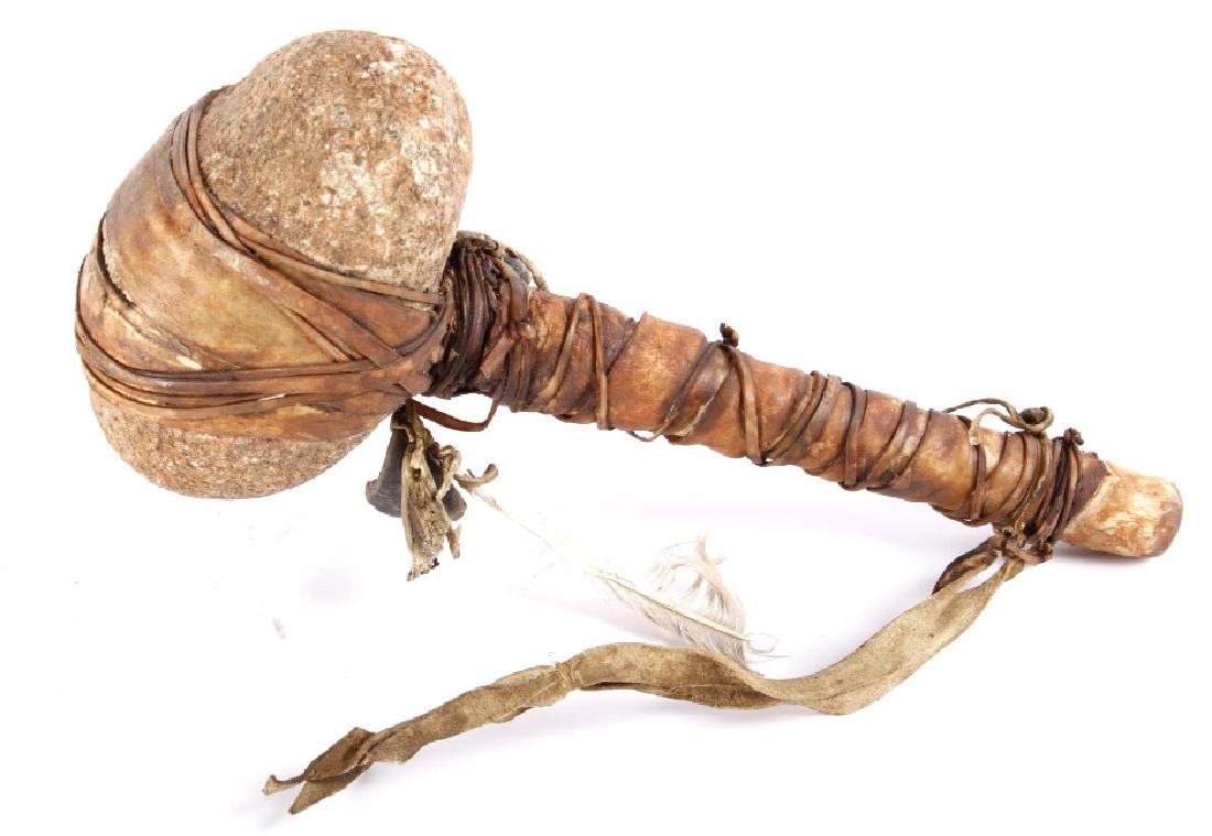 Northern Plains War Club Hammer Early 1900's: Provided for bidding in this lot is a Northern Plains Native American Indian, war club hammer. The club shows a massively broad stone, secured to the haft of the club with thick leather straps, and ad