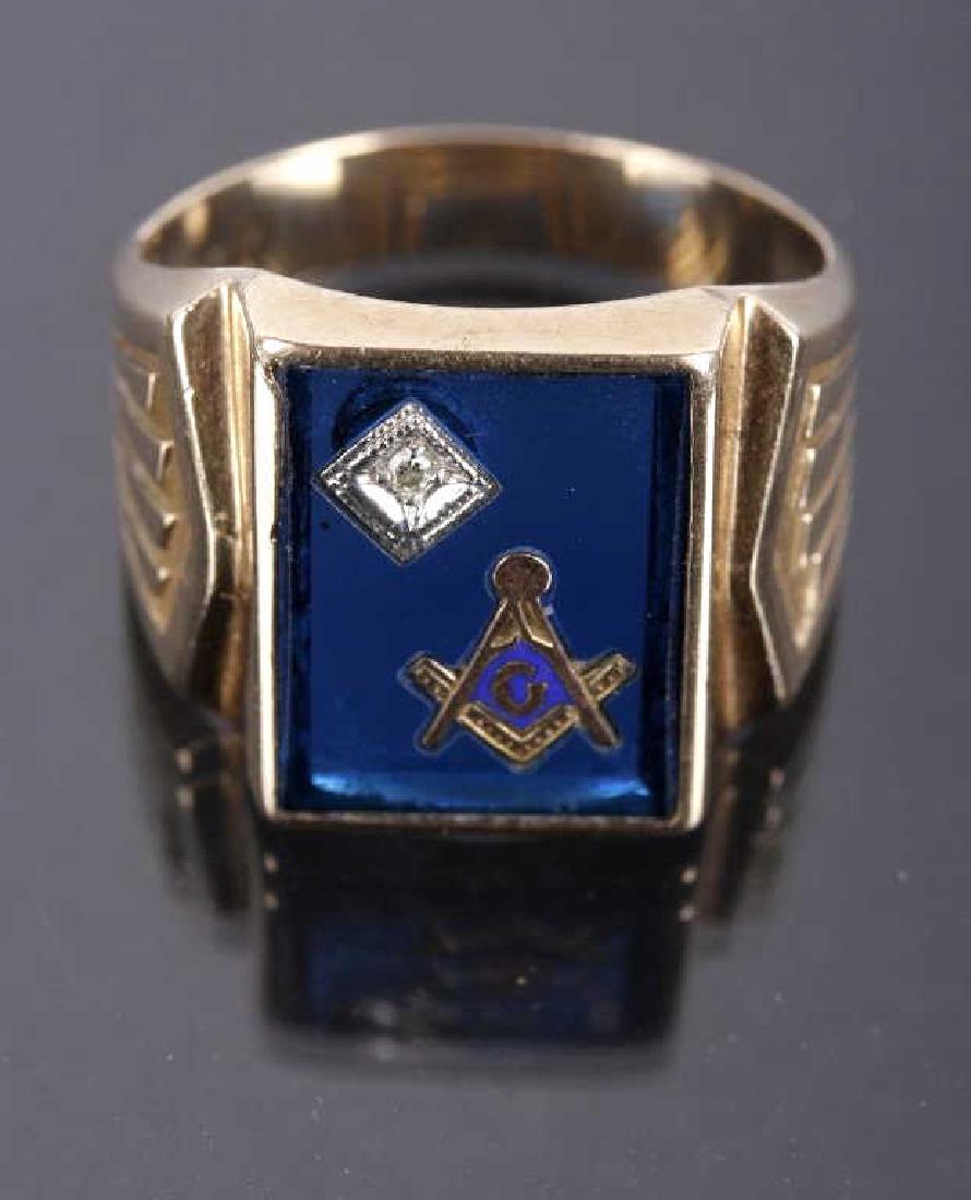 10k Gold & Diamond Masonic Ring: This item is a 10 karat gold and diamond, Masonic ring. The ring shows the Freemasons "Square and Compasses" logo, with a diamond set to the top left, all set into a slab of what is believed to be tra