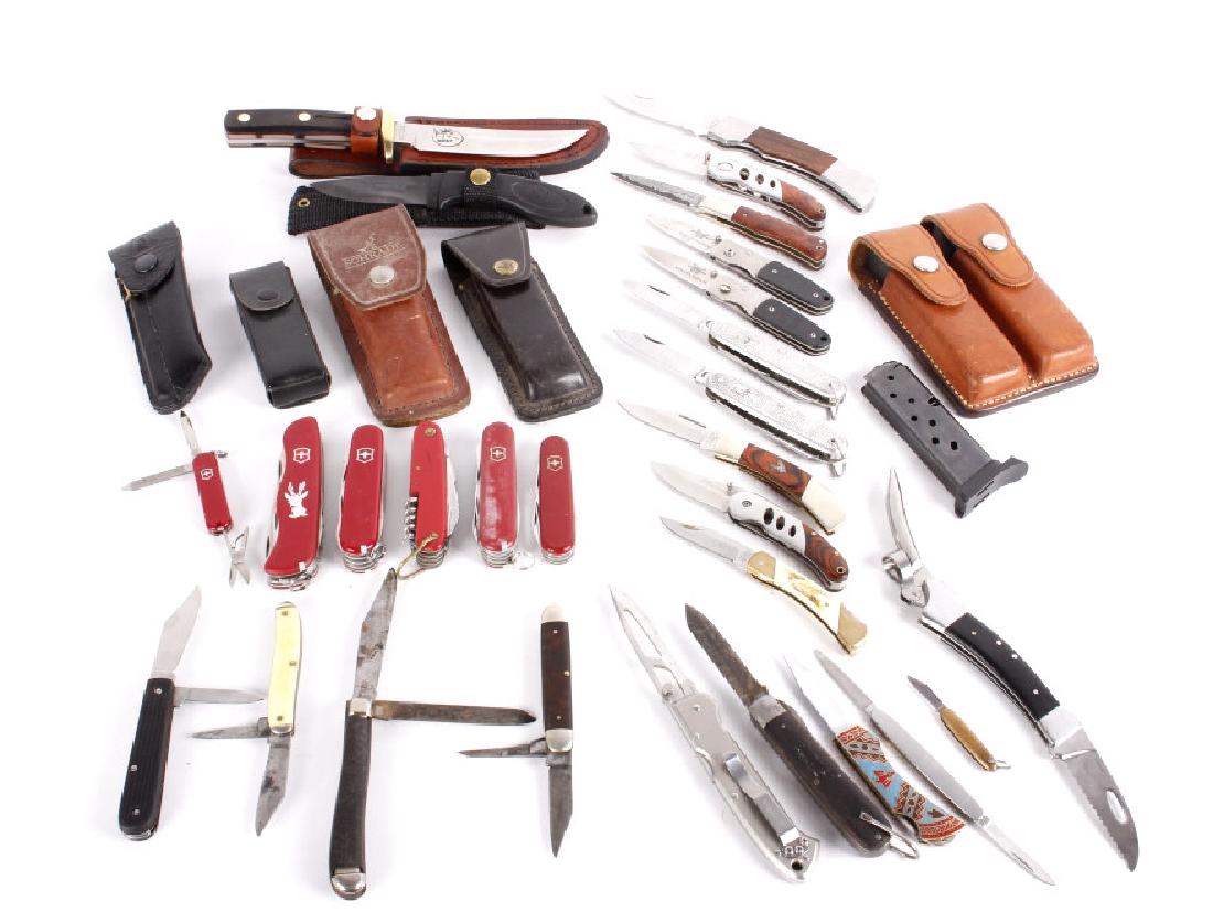 Large Assorted Knife Collection: This lot contains a 34 piece assorted set of 2 fixed blade knives, 23 folders, 6 swiss army knives (one swiss army repro), 1 multi-tool, and 3 pistol magazines, 2 of which include a Bianchi carry case
