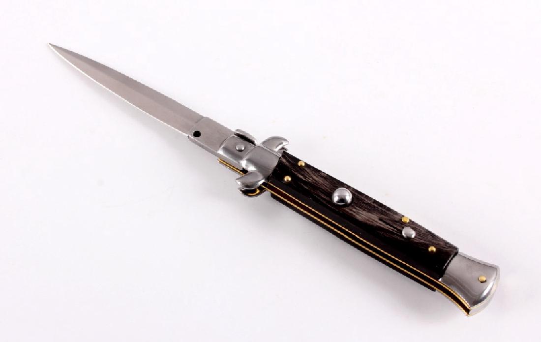 Frank Beltrame Italian Stiletto Switchblade Knife: This is a Frank Beltrame stiletto switchblade knife with a buffalo horn handle. The knife features a bayonet style blade marked "Frank B. Italy". The switchbalde knife is in very good condition with a