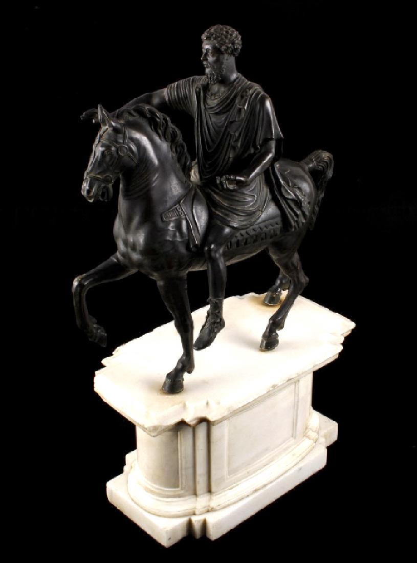 Grand Tour Equestrian Statue of Marcus Aurelius: This lot offers an early grand tour souvenir, bronze statue of Roman Emperor Marcus Aurelius on horseback. The bronze sits on a large marble plinth, composed of three solid, carved chunks of white mar