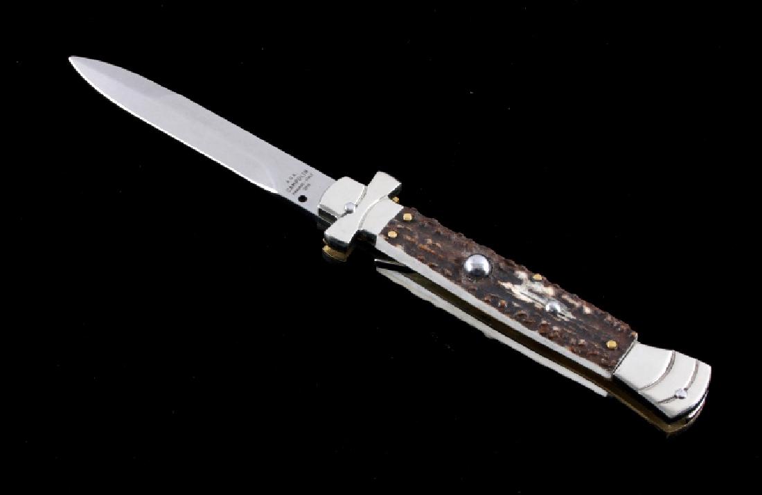 Campolin Maltese Cross Italian Switchblade Knife: This is a genuine Campolin imported Italian made Maltese Cross stiletto switchblade knife. The knife features the Maltese Cross hilt and stag horn grips with a push button to release the bayonet style