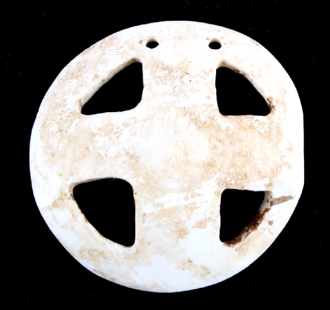 Early Fenestrated Carved Shell Gorget: The lot features an original authentic fenestrated carved shell gorget attributed to the Eastern Woodlands Great Lakes Indians or the Mississippian Culture. The piece shows a fenestrated carved design