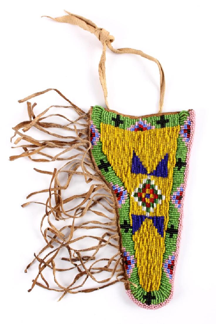 Sioux Indian Beaded Hide SAA Holster: This is a Sioux Native American Indian beaded hide holster from the early to mid 1900's and made for a single action style revolver. The front of the holster shows a fantastic geometric beaded design 