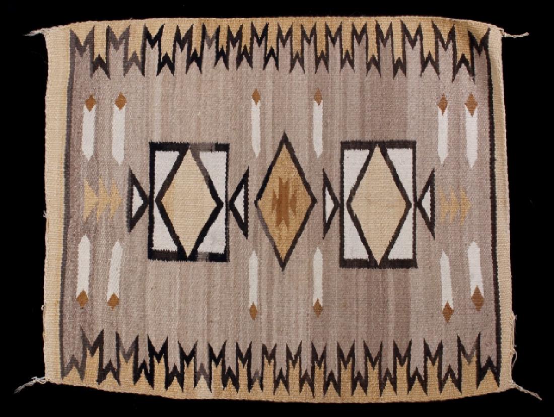 Navajo Two Grey Hills Pattern Wool Rug: Offered to you in this lot is a Navajo Native American Indian wool rug. The rug follows the Two Grey Hills pattern, with a central diamond motif, surrounded by accenting geometric pattern. The border 