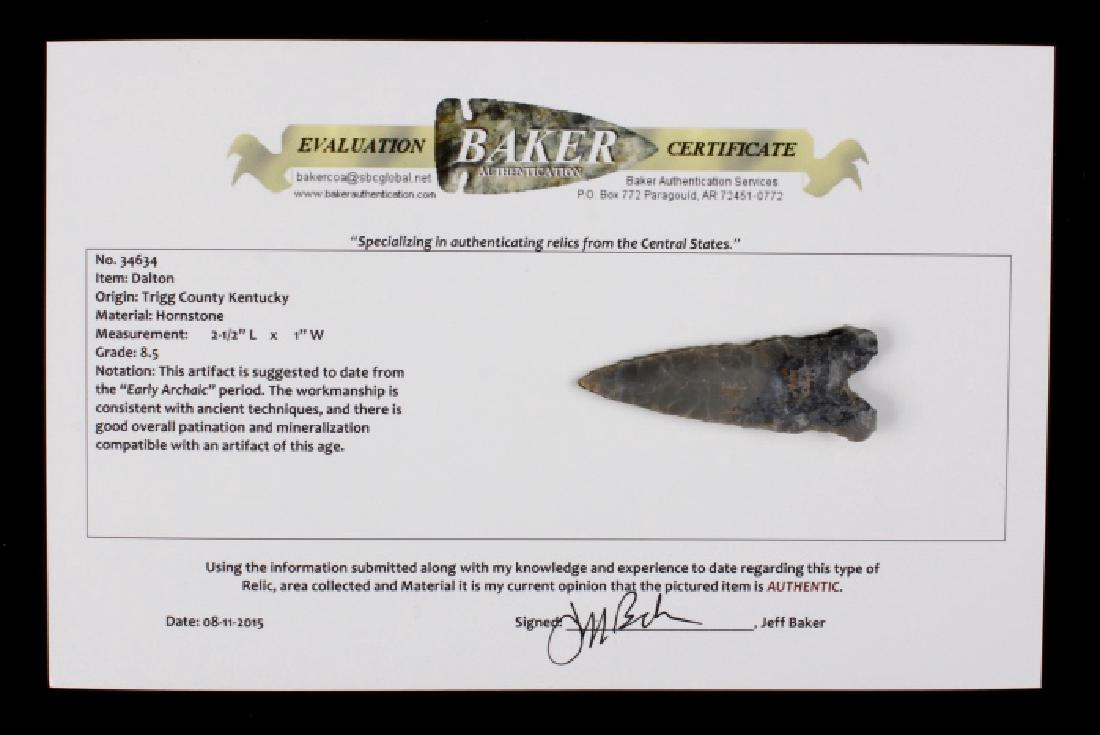 Early Archaic Period Hornstone Dalton Point: Offered for bidding in this lot is an early archaic period (8,000 - 1,000 BC) Dalton Point, originating from Trigg County, Kentucky. The Dalton Point includes a Certificate of Authenticity from "Baker