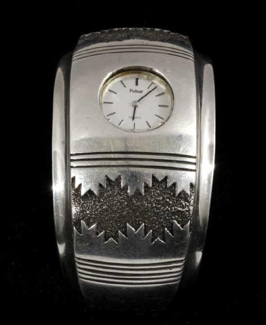 Alfred Joe Navajo Sterling Silver Cuff Watch: You can bid on a gorgeous Navajo Native American Indian watch, crafted of sterling silver by expert Navajo silversmith Alfred Joe. The watch utilizes a pulsar timepiece, which is framed excellently wi