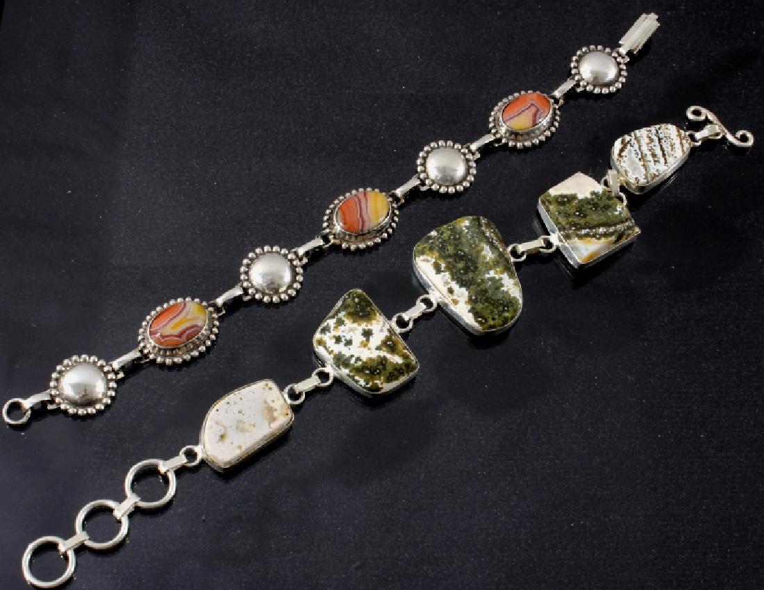 Two Sterling And Agate Link Bracelets: This lot features two sterling and agate link bracelets. The first bracelet has irregular shaped cabachons of tree agate (3) and picture jasper (2) set in and linked with Sterling Silver--marked "925"