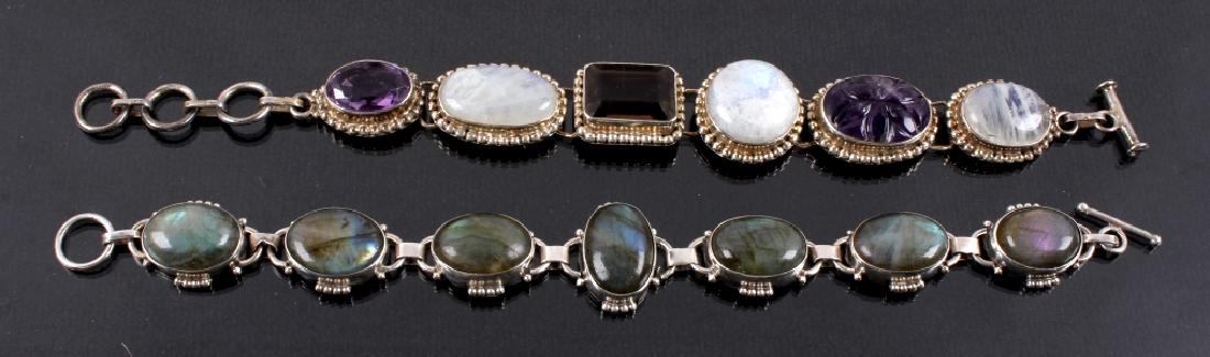 Two Sterling Silver And Gemstone Link Bracelets: Offered for your consideration is this lot of two Sterling Silver and gemstone link bracelets. The first bracelet features seven oval Labradorite gemstones set in Sterling Silver. The bracelet is abou