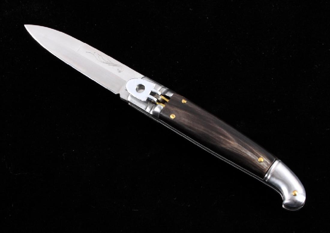 INOX German Lever Lock Buffalo Horn Switchblade: This is an INOX German made lever lock switchblade knife. The knife features a genuine buffalo horn handle with a hardened steel bayonet style blade that is marked "INOX". The switchblade knife shows