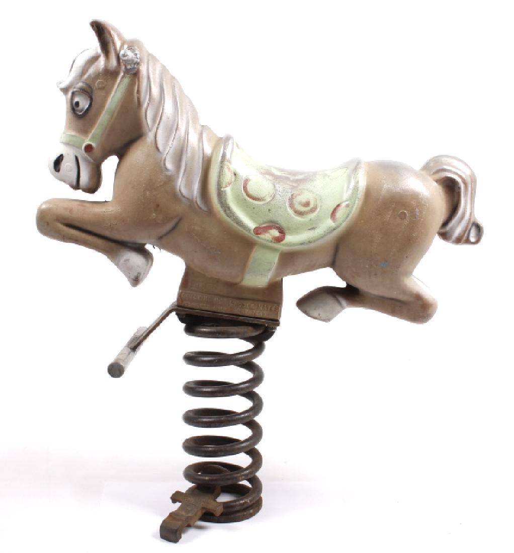 Amusement Park Cast Iron Rocking Horse Playground: This lot includes an antique cast iron children's amusement park, or playground rocking horse. The horse displays a polychrome paint job, and has its legs tucked up, as its in mid gallop. The horse si