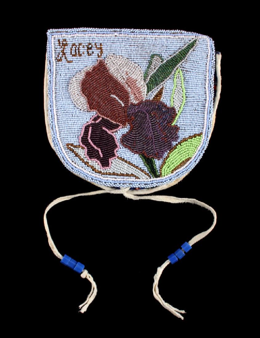 Nez Perce Fully Beaded Floral Belt Pouch: The lot features a unique fully front beaded belt pouch attributed to the Nez Perce Native American Indians of Washington. The belt pouch, or other times referred to as a pelt panel, shows an Indian t