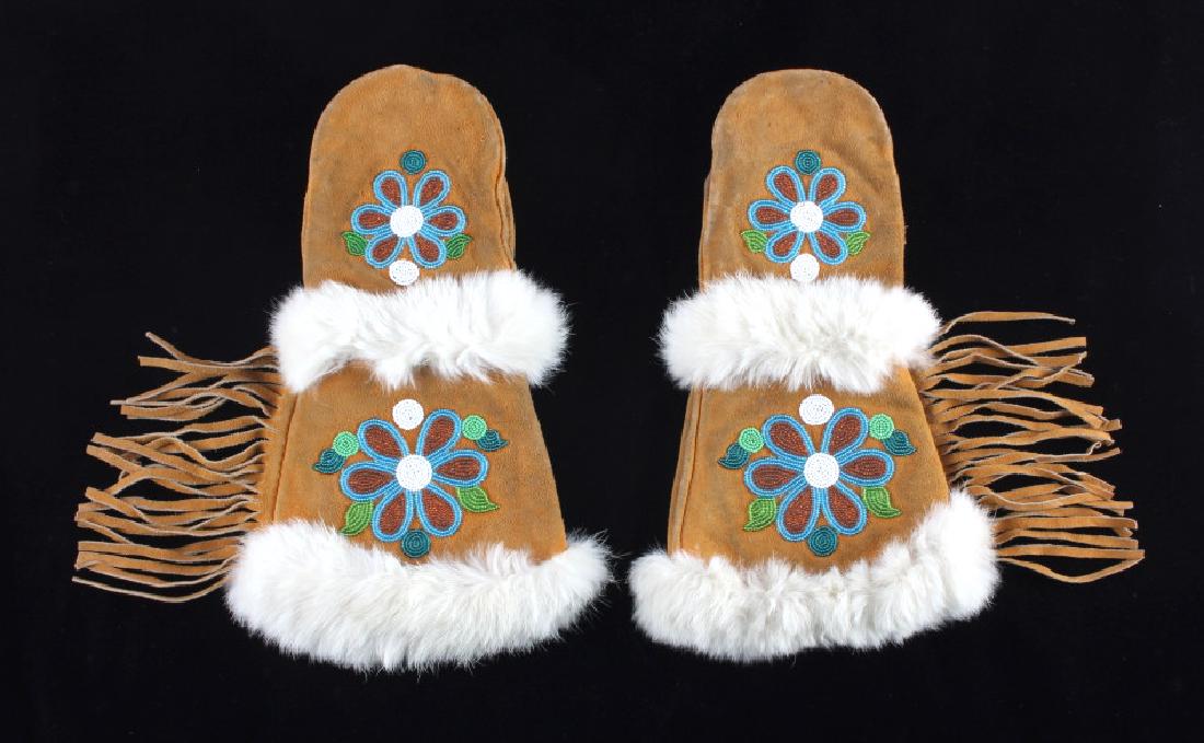 Montana Crow Floral Beaded Gauntlet Gloves: This is a set of floral beaded gauntlet glove mittens attributed to the Crow Native American Indians of Montana. The set shows an Elk Indian Tanned hide construction with blanket trade fabric lining s