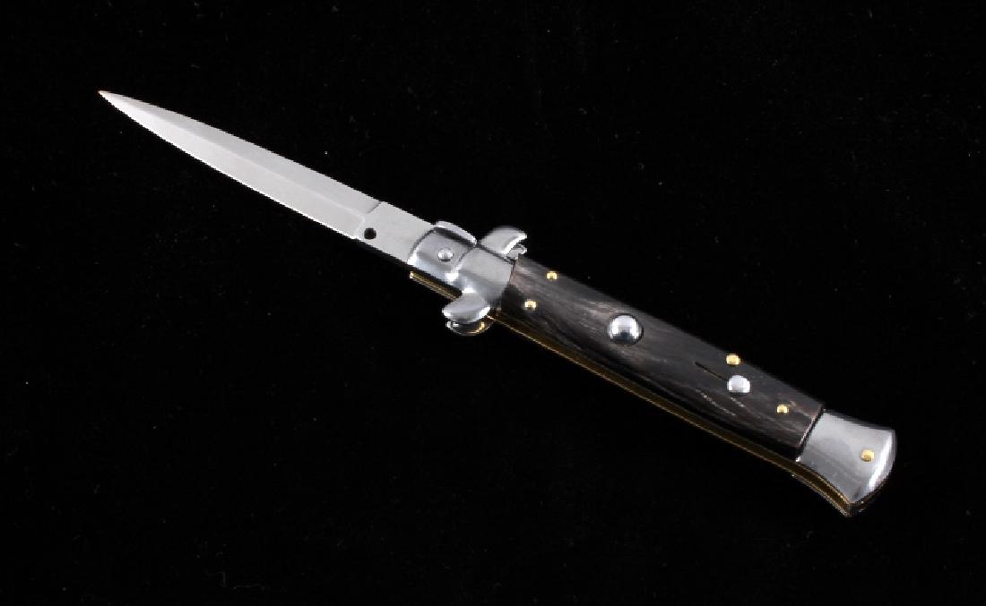 Frank Beltrame Italian Stiletto Switchblade Knife: This is a Frank Beltrame stiletto switchblade knife with a buffalo horn handle. The knife features a bayonet style blade marked "Frank B. Italy". The switchblade knife is in very good condition with a
