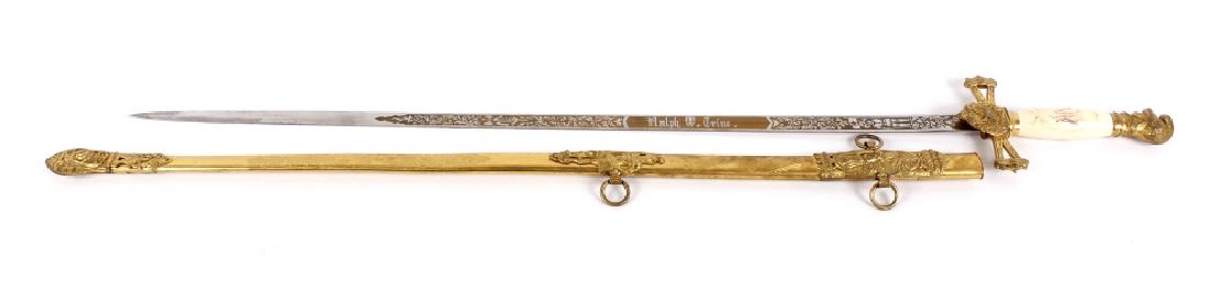 Ornate Henderson Ames Co. Fraternal Order Sword: This lot contains a Henderson Ames Company, Knights Templar, Masonic fraternal order sword, originating from Kalamazoo Michigan, between the late 1800's or early 1900's. The sword has a brass scabbard