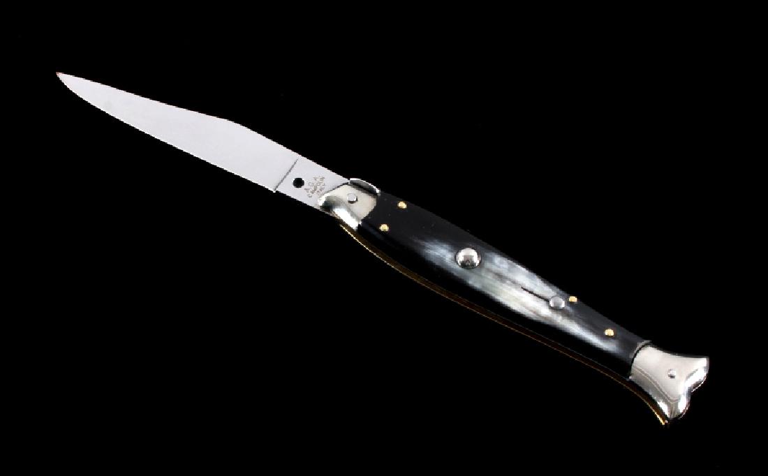 Campolin Buffalo Horn Fishtail Switchblade Knife: This is an Italian made Campolin fishtail stiletto switchblade knife. The knife features a hardened stainless steel blade with a genuine buffalo horn grips. The bolsters are made from nickel silver wi