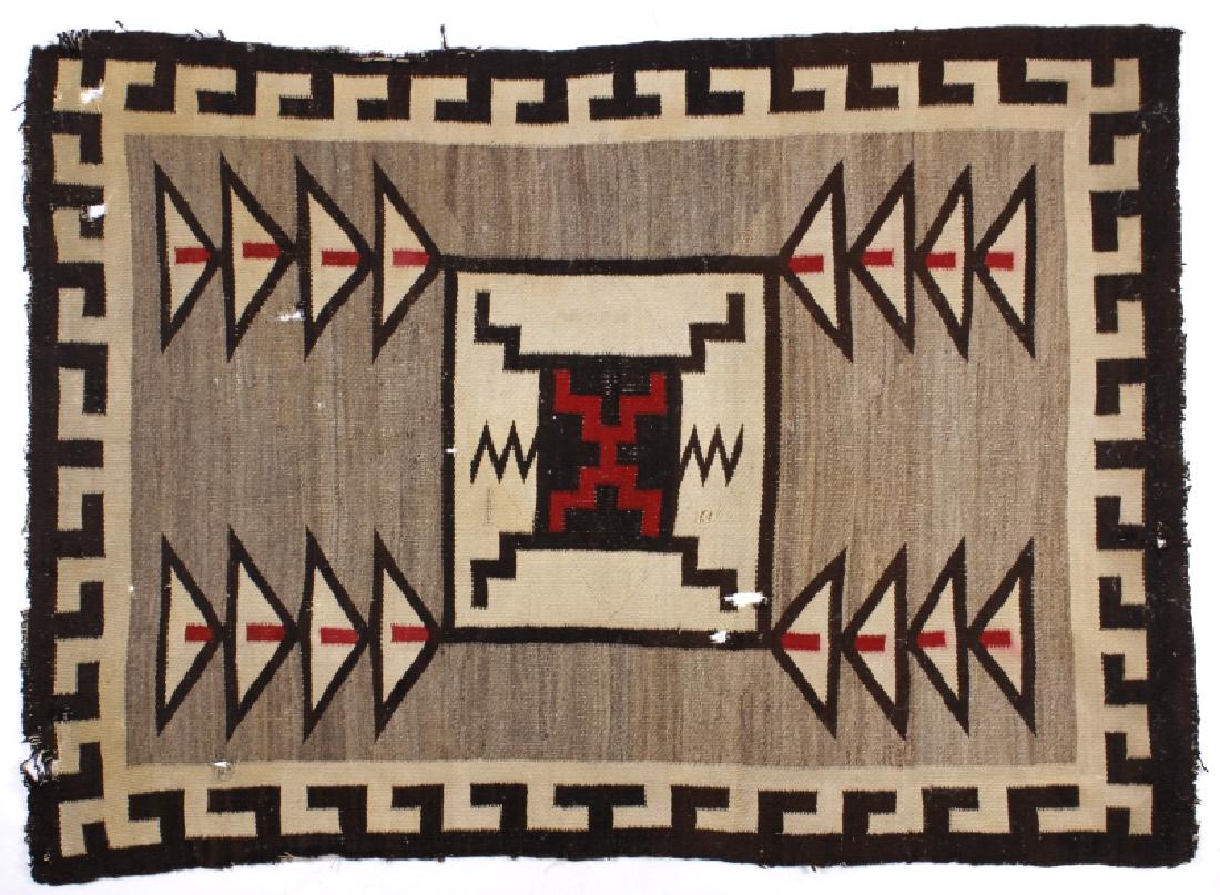 Navajo Klagetoh Pattern Wool Rug circa 1900: Offered for sale in this lot is a Navajo Native American Indian wool rug, woven in the Klagetoh pattern. The rug shows a central storm pattern medallion, flanked on all corners with polychrome geometr