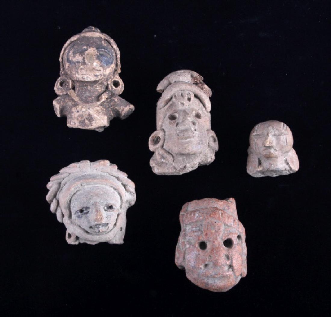 Mayan Pottery Figural Effigy Collection: This is a collection of five Mayan pottery figural effigies. Each piece shows a human head figure with some exhibiting the original paint and markings. The Mayan figural effigies are in good overall c