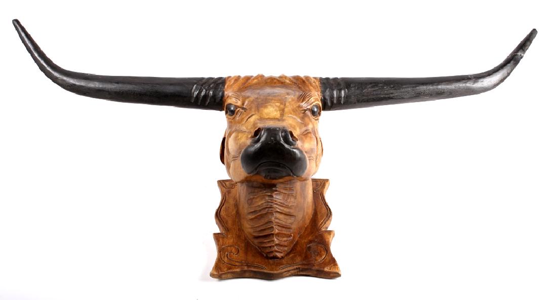 Antique Folk Art Carved Longhorn Steer Trade Sign: This is an original antique folk art carved Longhorn Steer trade sign. The piece shows a steer head carved out of a solid piece of wood to look like a shoulder mount. Carved and painted black, attache