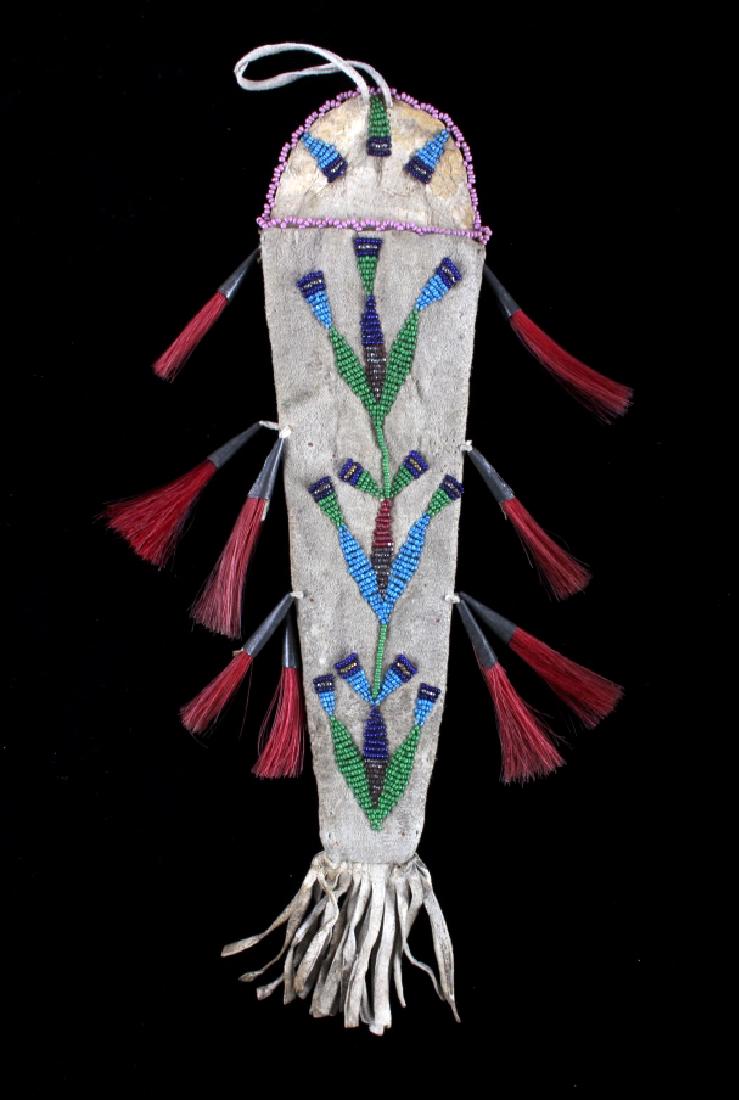 Santee Sioux Beaded Dag Knife Sheath c. 1890: This is an excellently beaded knife sheath from the Santee Sioux Native American Indians of Nebraska and dates to circa 1890's. The piece shows an Indian tanned Bison Buffalo hide with early calico pa