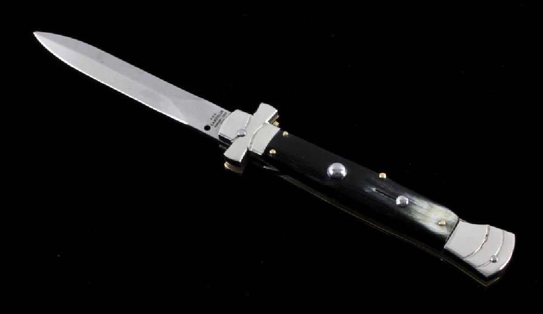 Campolin Maltese Cross Italian Switchblade Knife: This is a genuine Campolin imported Italian made Maltese Cross stiletto switchblade knife. The knife features the nickel silver Maltese Cross hilt and buffalo horn grips with a push button to release 