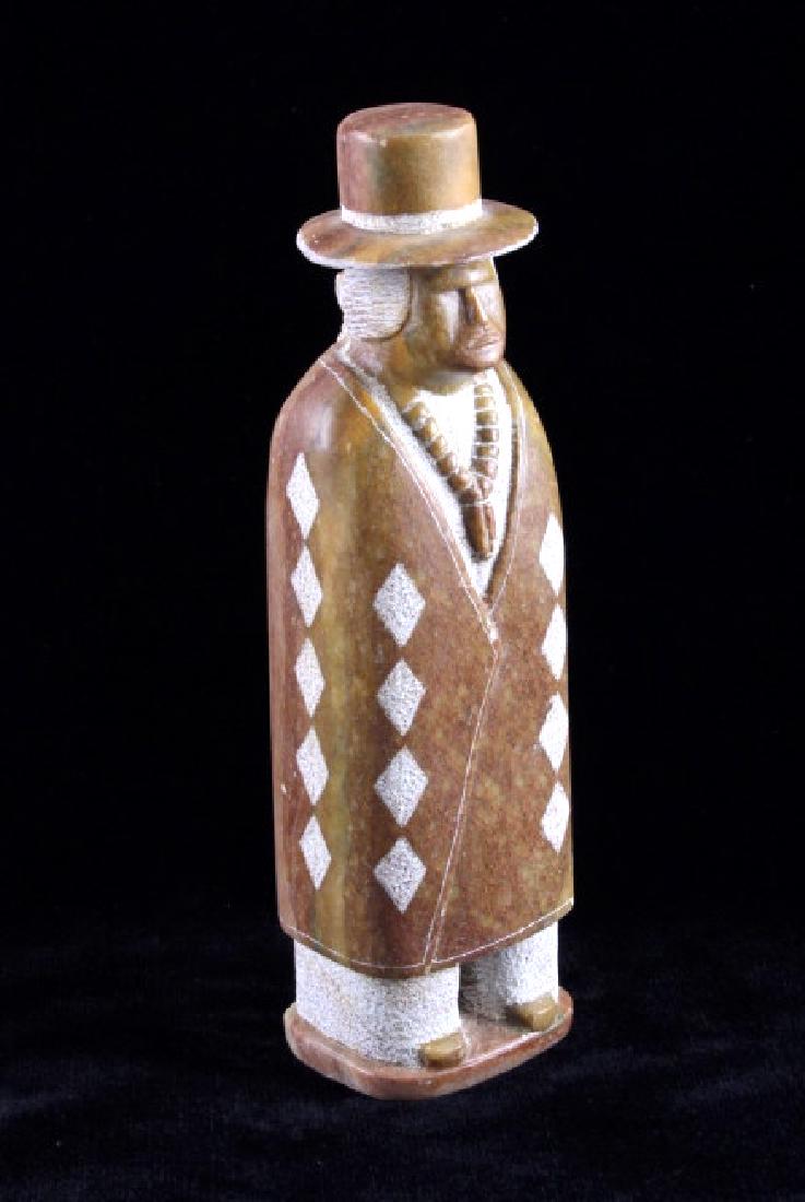 Gilbert Yazzie Navajo Carved Stoned Indian Figure: This is a signed Navajo Native American Indian carved stone figure made by Gilbert Yazzie. The piece is carved from Utah alabaster and shows an Indian figure wearing a wide brimmed hat and wrapped in