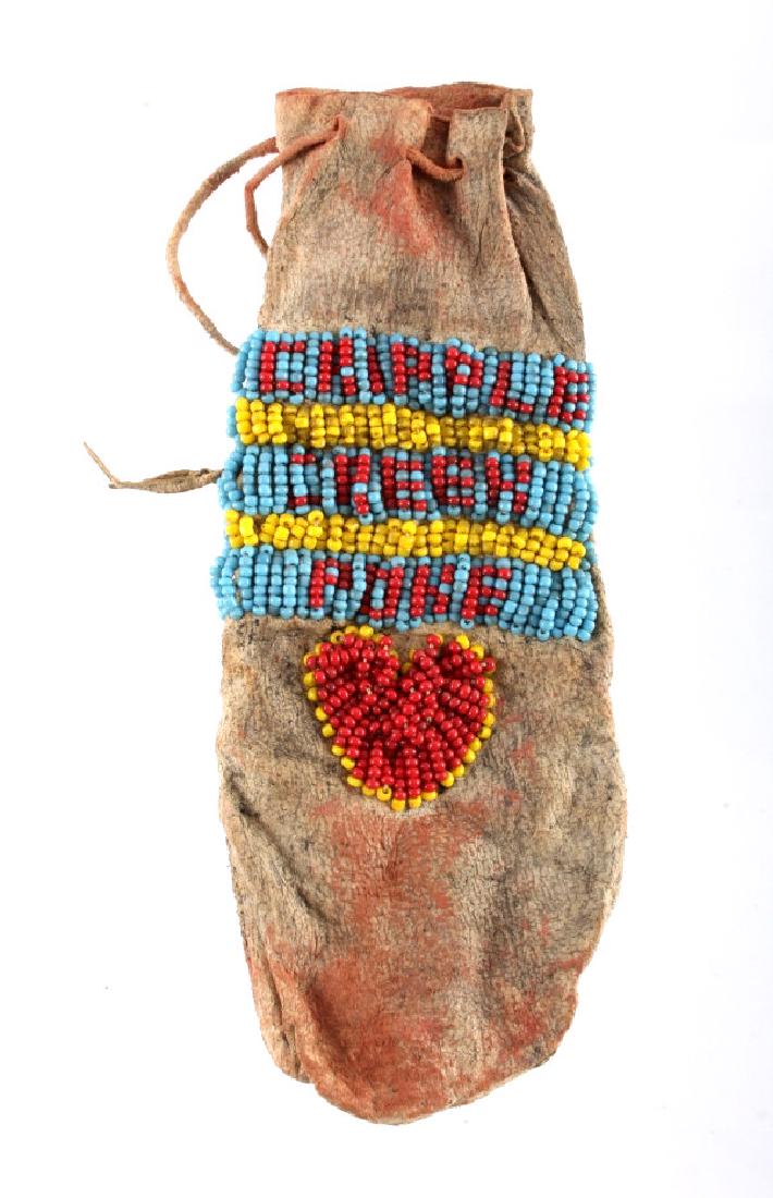 Comanche Beaded War Paint Pouch circa 1890-1900's: The lot features an unusual beaded war paint pouch from the Comanche Native American Indians from the plains of Texas. The bag, dating to circa 1880-1900’s, shows traces of old red powder pigment on