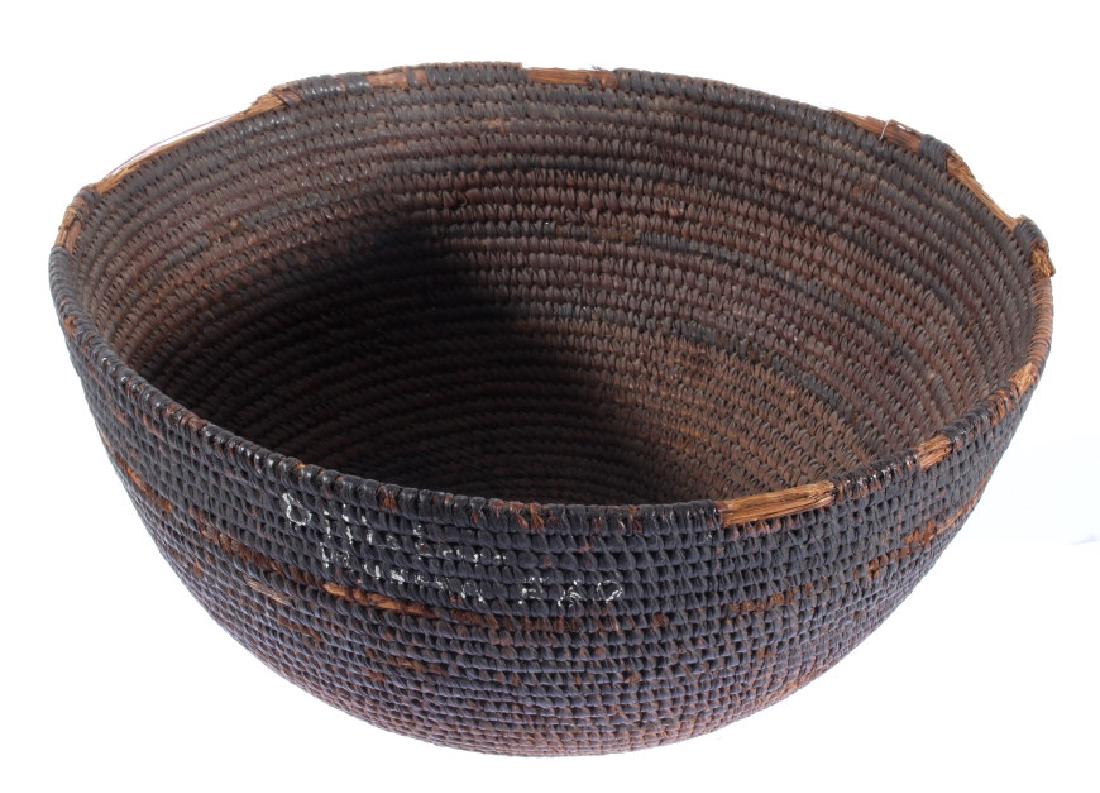 Early Hopi Woven Basket w/ Museum Mark 1800's: This auction lot gives you the chance to bid on an antique Hopi Native American Indian basket. The basket is made of hand-woven pine needles in a coiled formation. The basket's coloring is light brown